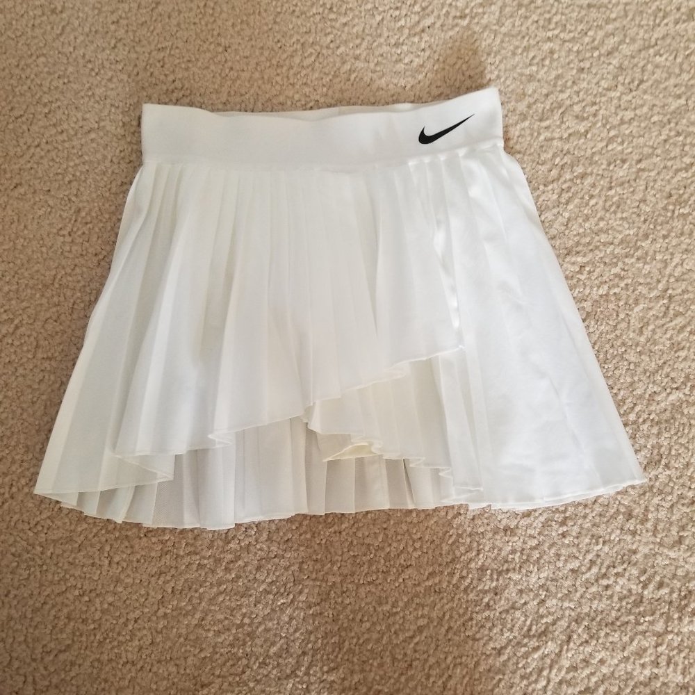 Nike Dri-Fit pleated white tennis skirt.   Size Small. Asymetric hem.